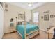 Bright bedroom features a four-poster bed with bright-colored bedding, and classic furnishings at 4714 Seneca Park Trl, Bradenton, FL 34211