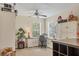Inviting bedroom has dual desks, bright light, ceiling fan, and decorative accents at 4714 Seneca Park Trl, Bradenton, FL 34211