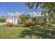 Charming home featuring a three-car garage, well-manicured lawn, and colorful landscaping at 4714 Seneca Park Trl, Bradenton, FL 34211