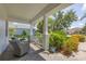 Cozy front porch featuring comfortable seating and lush landscaping, perfect for relaxing outdoors at 4714 Seneca Park Trl, Bradenton, FL 34211