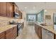 Stylish kitchen featuring granite countertops, tile backsplash, stainless steel appliances, and custom cabinetry at 4714 Seneca Park Trl, Bradenton, FL 34211