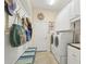 Functional laundry room with a bench, storage, washer and dryer, and wall decorations at 4714 Seneca Park Trl, Bradenton, FL 34211