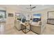 Bright living room featuring a ceiling fan, tile flooring, and sliding glass doors to an outdoor patio at 4714 Seneca Park Trl, Bradenton, FL 34211