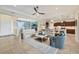Open-concept living room featuring tile flooring, comfortable seating, and seamless flow to the kitchen and dining area at 4714 Seneca Park Trl, Bradenton, FL 34211
