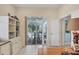 Bright living room features a tiled floor, views of the pool, and a built-in bookcase at 4714 Seneca Park Trl, Bradenton, FL 34211