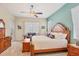 Serene main bedroom with a ceiling fan, sitting area, and lots of natural light at 4714 Seneca Park Trl, Bradenton, FL 34211