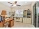 Functional office space with built-in desk and storage, bright light, and slider door at 4714 Seneca Park Trl, Bradenton, FL 34211
