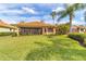 Green lawn and patio offer relaxation and outdoor living surrounded by lush landscaping at 5179 Cantabria Crst, Sarasota, FL 34238