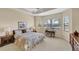 Cozy bedroom with tray ceiling, plush carpeting, bright windows, and comfortable furnishings offering a peaceful retreat at 5179 Cantabria Crst, Sarasota, FL 34238