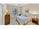 Charming bedroom offers a bright window, plush carpet, and serene decor creating a peaceful and relaxing atmosphere at 5179 Cantabria Crst, Sarasota, FL 34238
