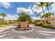 Attractive community entrance with lush tropical landscaping, flowers, and a decorative sign creating a welcoming impression at 5179 Cantabria Crst, Sarasota, FL 34238