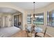 Cozy dining area boasting tile floors, natural lighting, and serene water views at 5179 Cantabria Crst, Sarasota, FL 34238