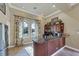 Cozy kitchenette featuring dark wood cabinets, granite countertops and light tile floors at 5179 Cantabria Crst, Sarasota, FL 34238