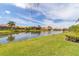 Scenic lake view showcasing community homes and lush landscaping, creating a tranquil outdoor setting at 5179 Cantabria Crst, Sarasota, FL 34238