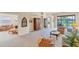 Spacious living room with neutral walls, plush carpeting, and views of the lake at 5179 Cantabria Crst, Sarasota, FL 34238