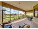 Screened patio overlooking a serene lake view with manicured lawn and community fountain at 5179 Cantabria Crst, Sarasota, FL 34238