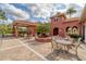 Outdoor patio area with tables, chairs, and lush landscaping at 5179 Cantabria Crst, Sarasota, FL 34238