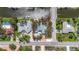 Aerial view of a waterfront home on a canal lot with tropical landscaping and easy access to nearby beaches at 5572 Shadow Lawn Dr, Sarasota, FL 34242