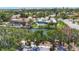 Aerial view featuring a home with a pool, lush landscaping, and canal access for boating, near beach at 5572 Shadow Lawn Dr, Sarasota, FL 34242