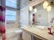 Well-lit bathroom features neutral tones, vanity lighting, and accessibility fixtures at 5572 Shadow Lawn Dr, Sarasota, FL 34242