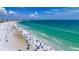 Wide aerial view of Siesta Key's beach, with vibrant turquoise water, sandy beach, and beachgoers enjoying the day at 5572 Shadow Lawn Dr, Sarasota, FL 34242