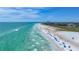 Panoramic view of Siesta Key beach with turquoise ocean waters, soft white sand, and vacationers enjoying the sunshine at 5572 Shadow Lawn Dr, Sarasota, FL 34242