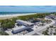 Aerial view of Siesta Beach, showcasing the modern building, beach access, and vibrant shoreline at 5572 Shadow Lawn Dr, Sarasota, FL 34242