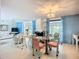 Open-concept living and dining area featuring a modern table, chairs, and ample natural light at 5572 Shadow Lawn Dr, Sarasota, FL 34242
