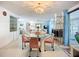 Open-concept living and dining area featuring a modern table, chairs, and ample natural light at 5572 Shadow Lawn Dr, Sarasota, FL 34242
