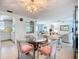 Open-concept living and dining area featuring a modern table, chairs, and ample natural light at 5572 Shadow Lawn Dr, Sarasota, FL 34242