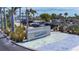Siesta Beach entrance featuring tropical landscaping, parking, and a clear view of the beach's public amenities at 5572 Shadow Lawn Dr, Sarasota, FL 34242