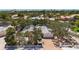 Aerial view of charming property with a spacious driveway, complemented by lush landscaping and serene neighborhood at 5572 Shadow Lawn Dr, Sarasota, FL 34242