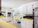 Bright kitchen features white cabinetry, modern appliances, and a unique yellow countertop at 5572 Shadow Lawn Dr, Sarasota, FL 34242