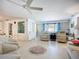 Spacious living room with built-in shelving, comfortable seating, and light-filled windows at 5572 Shadow Lawn Dr, Sarasota, FL 34242