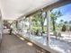 Enclosed sunroom with expansive windows offering scenic outdoor views and a bright, inviting space at 5572 Shadow Lawn Dr, Sarasota, FL 34242