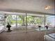 Relaxing sunroom with waterfront views, comfortable seating, and serene garden decor create a peaceful retreat at 5572 Shadow Lawn Dr, Sarasota, FL 34242