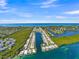 Aerial view of waterfront homes in tropical community with boat docks and lush surroundings at 564 Spanish N Dr, Longboat Key, FL 34228