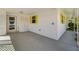 Attached carport with exterior storage; access door and jalousie window with bright yellow trim at 564 Spanish N Dr, Longboat Key, FL 34228
