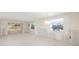 Renovation featuring plaster walls, new fixtures, and a doorway to a bright sunroom with lots of natural light at 564 Spanish N Dr, Longboat Key, FL 34228