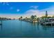 Beautiful evening waterfront view featuring a canal with boats docked along the side, lined with palm trees at 564 Spanish N Dr, Longboat Key, FL 34228