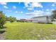 A large backyard with green grass, showcasing the property's size and potential at 6103 6Th Nw Ave, Bradenton, FL 34209
