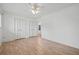 Bedroom with ceiling fan, two closets, wood-look flooring and white walls at 6103 6Th Nw Ave, Bradenton, FL 34209