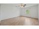 Light-filled bedroom with ceiling fan, wood-look flooring, and a window view of the outdoors at 6103 6Th Nw Ave, Bradenton, FL 34209