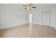 Spacious bedroom features wood-look flooring, ceiling fan, closet, and open doorway at 6103 6Th Nw Ave, Bradenton, FL 34209