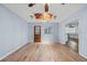 Dining space with hardwood floors, a skylight, and a chandelier, open to other living areas at 6103 6Th Nw Ave, Bradenton, FL 34209