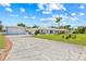 Long driveway leads up to this charming single-story home, complete with a detached garage and lush front lawn at 6103 6Th Nw Ave, Bradenton, FL 34209