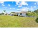 Beautifully landscaped front yard frames this single-story home, with healthy green grass and clear blue skies at 6103 6Th Nw Ave, Bradenton, FL 34209