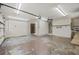 Large garage with an overhead door, storage areas, and pedestrian door to the house at 6103 6Th Nw Ave, Bradenton, FL 34209