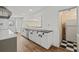 Traditional style kitchen with white cabinets and black countertop, offering a view to additional space at 6103 6Th Nw Ave, Bradenton, FL 34209