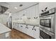 Modern kitchen with stainless steel appliances, white cabinets, and sleek design, creating a culinary space at 6103 6Th Nw Ave, Bradenton, FL 34209